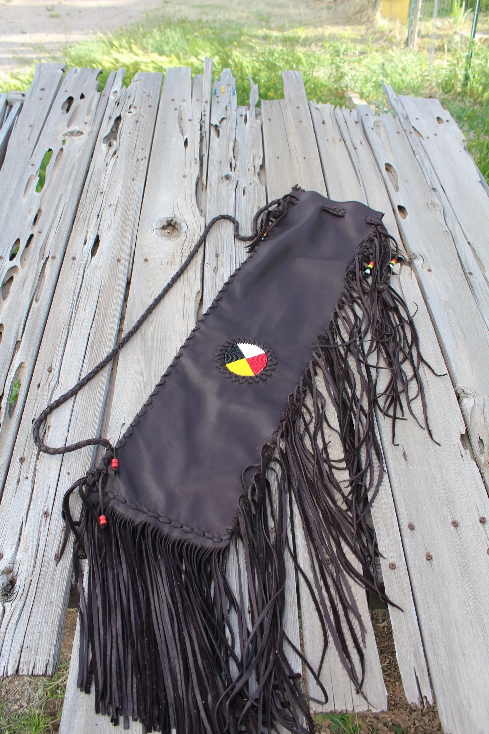 Fringed leather flute bag with beaded medicine wheel