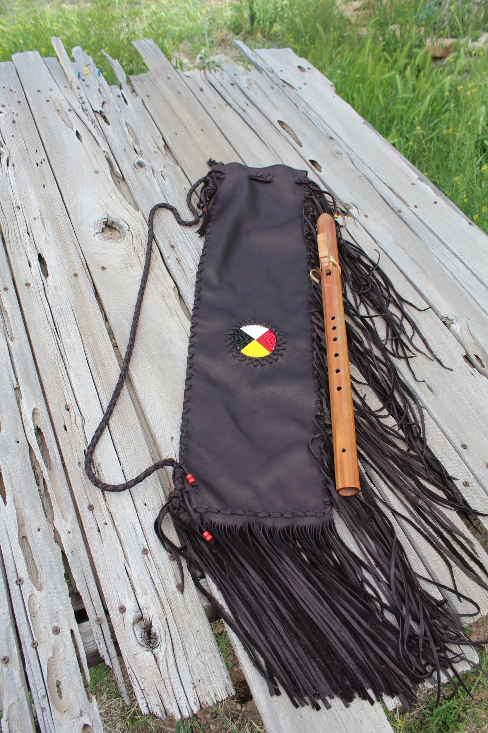 Fringed leather flute bag with beaded medicine wheel