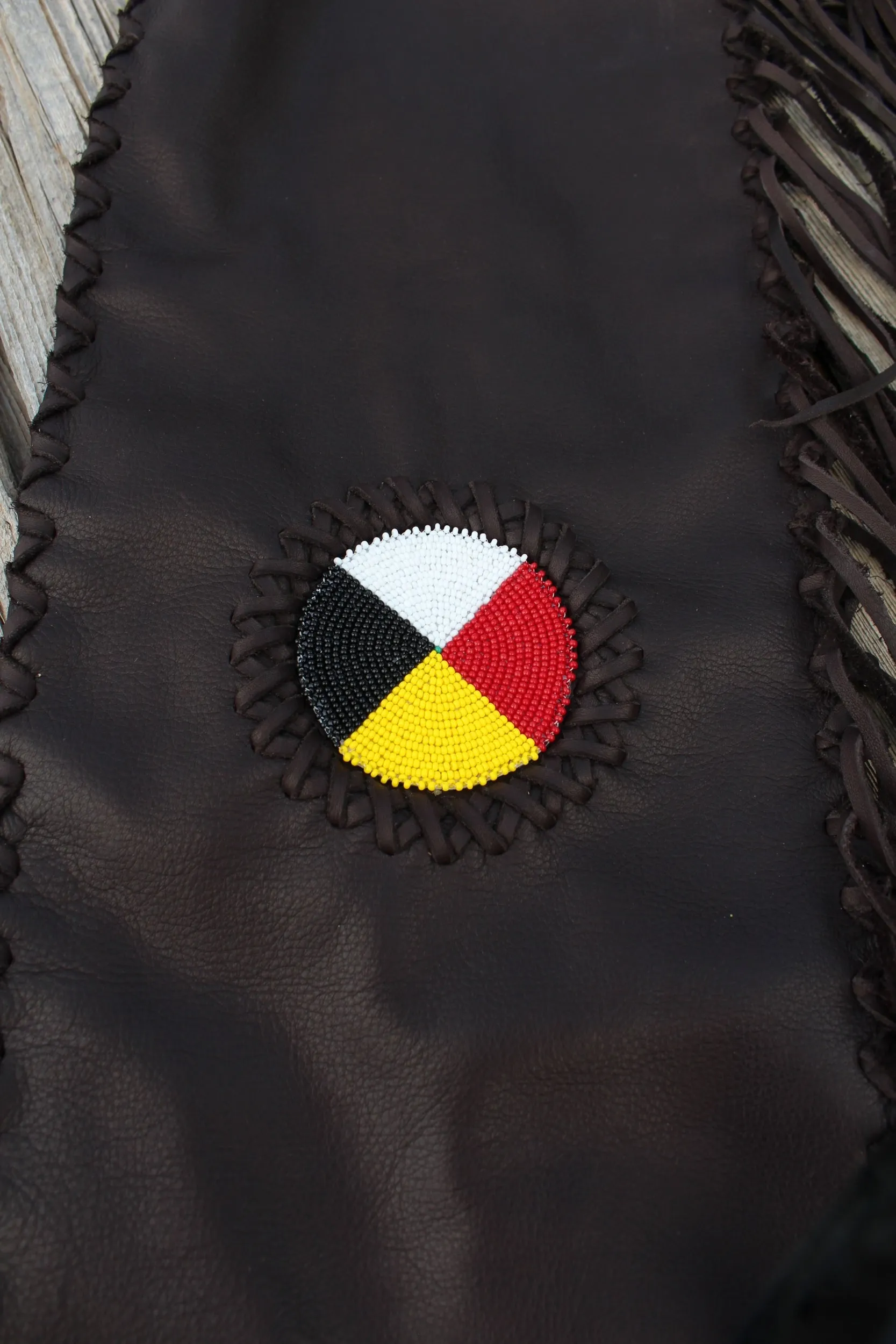 Fringed leather flute bag with beaded medicine wheel