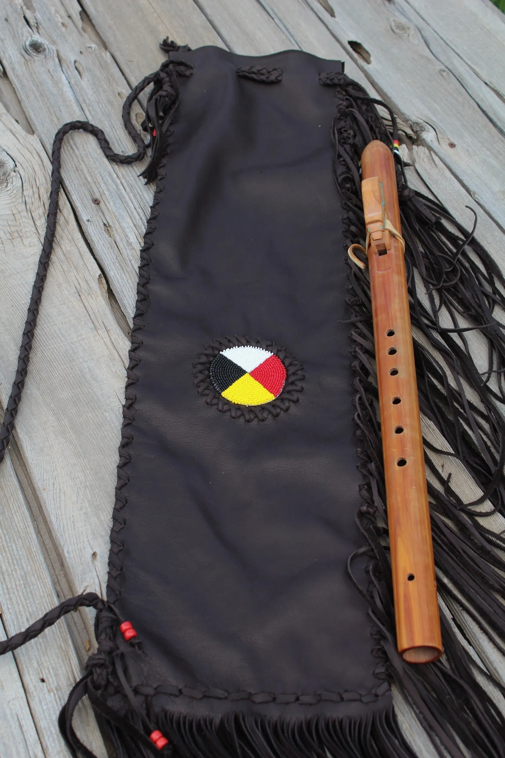 Fringed leather flute bag with beaded medicine wheel